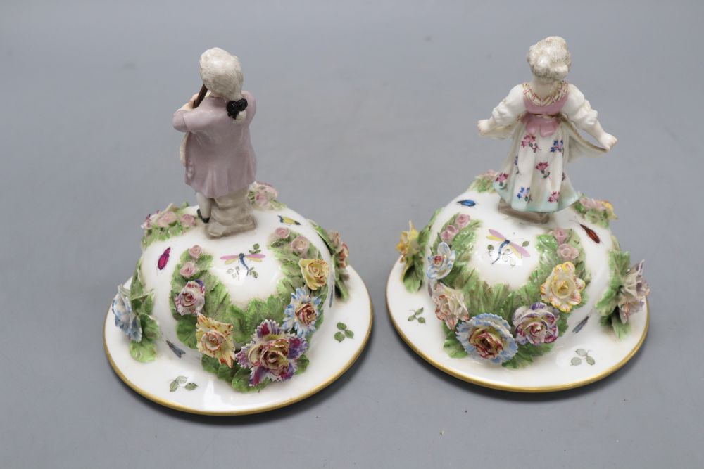 A pair of Augustus Rex floral encrusted porcelain vases and covers and a similar putti centrepiece, tallest 37cm